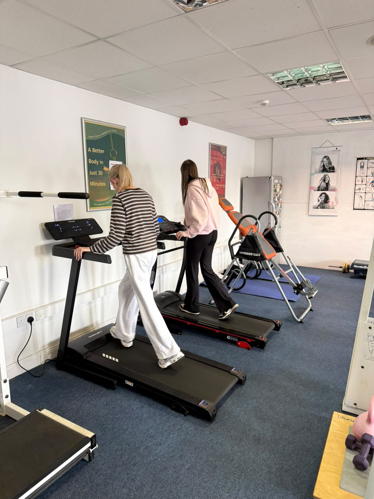 Two members walking on treadmills at Fitness Express